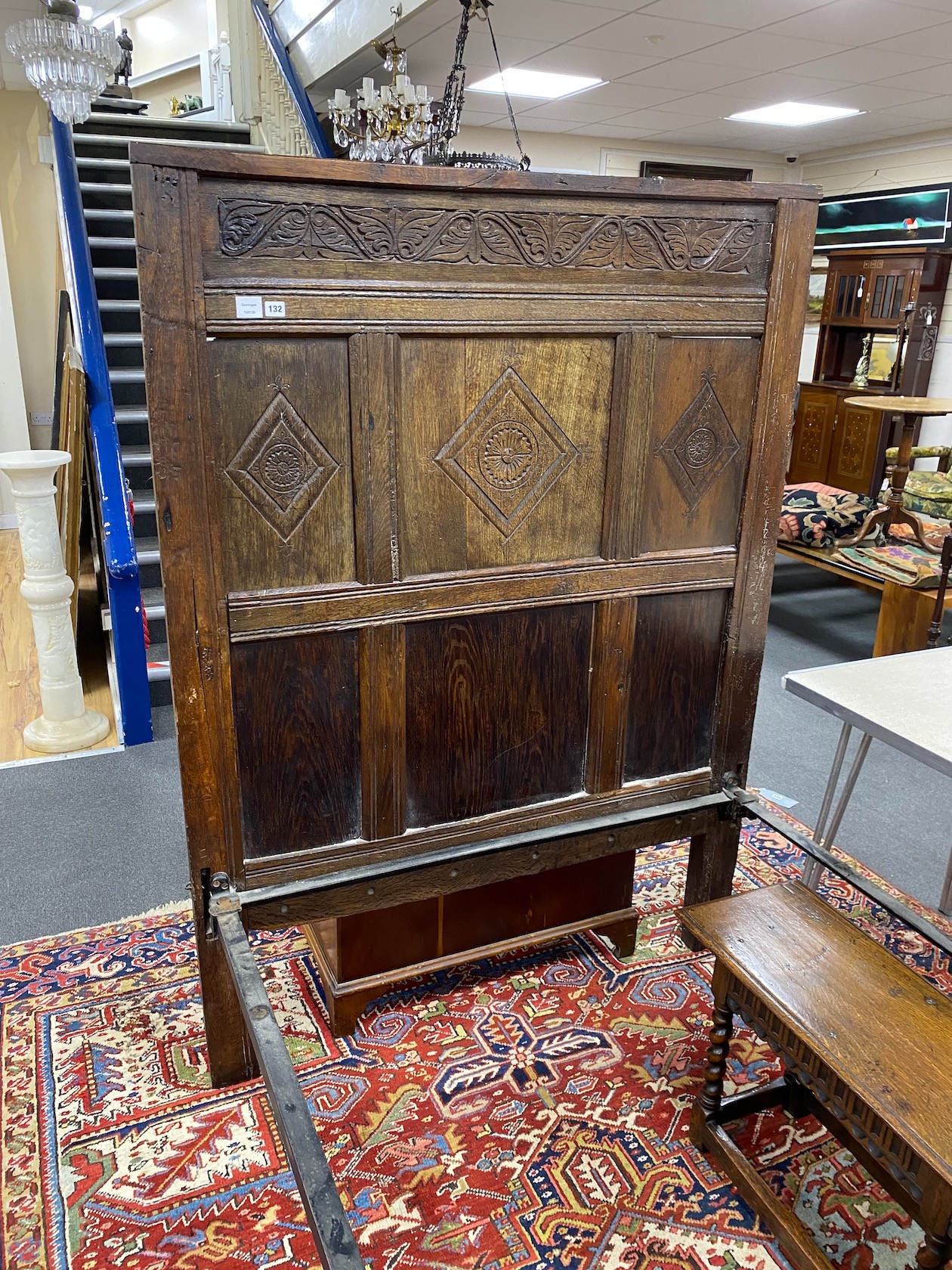 A 17th century style carved oak single head and foot bedstead, length 210cm, width 127cm, height 172cm